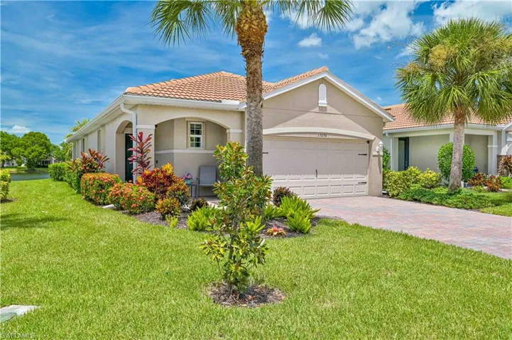 Mediterranean / spanish house with a garage and a front yard