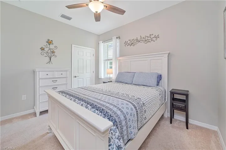 Bedroom featuring light carpet and ceiling fan