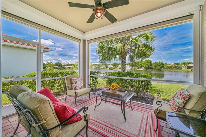 Sunroom featuring a water view and ceiling fan