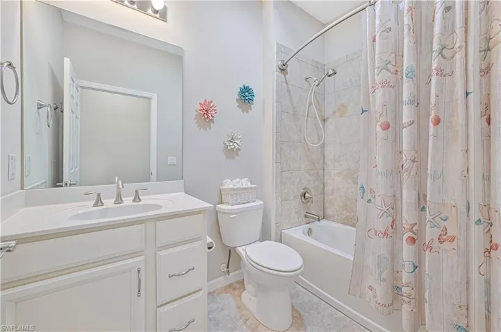 Full bathroom featuring vanity, tile patterned flooring, toilet, and shower / bath combo