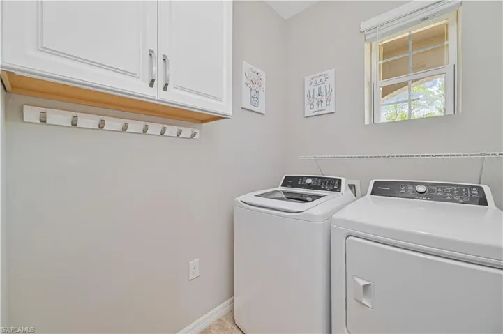 Laundry area with washing machine and dryer and cabinets