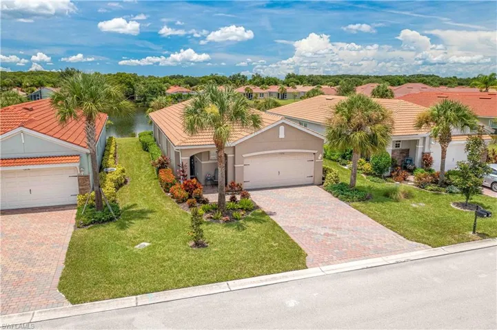 Mediterranean / spanish-style home featuring a garage and a front lawn