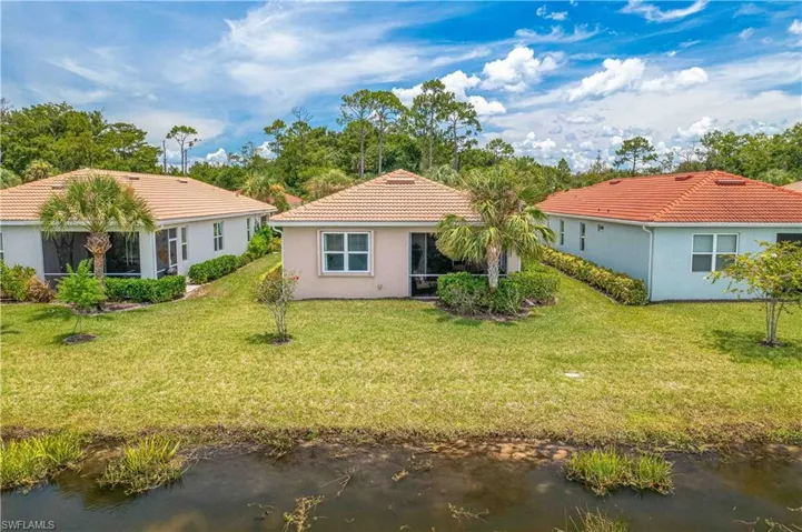 Rear view of property with a yard
