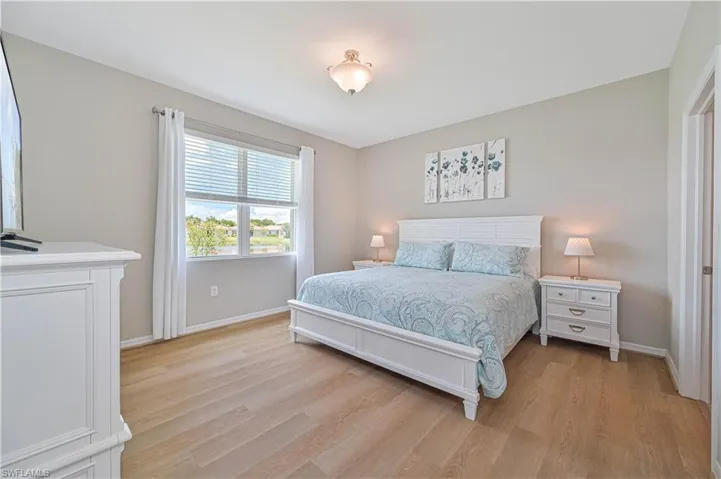 Bedroom with light hardwood / wood-style flooring