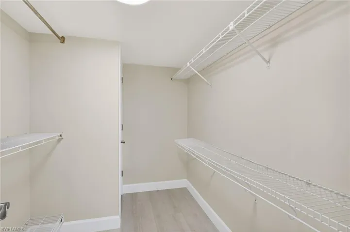 Walk in closet featuring light vinyl finished floors