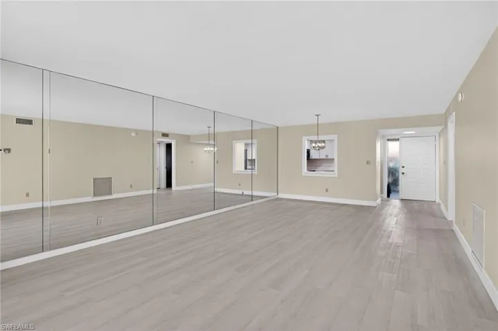 Empty room featuring light vinyl finished floors and baseboards