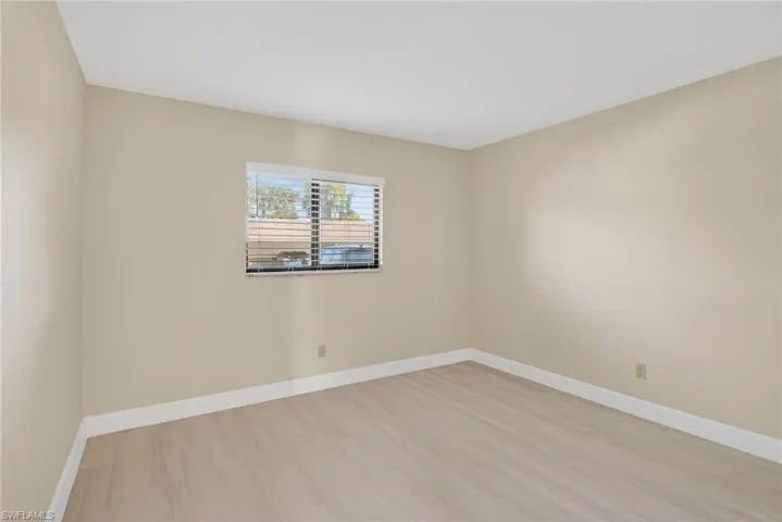 Empty room with baseboards and light vinyl-type flooring