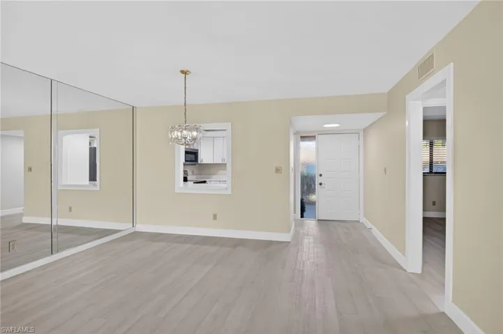dining area with light vinyl-style flooring and a chandelier