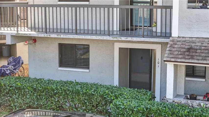 Doorway to property featuring stucco siding