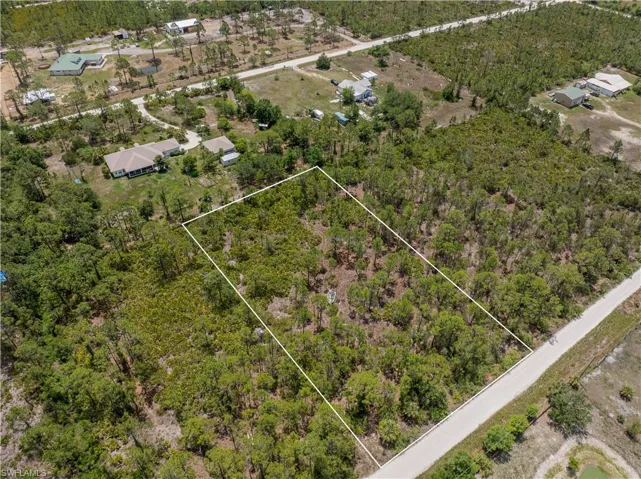 Aerial view of property and surrounding area with property parcel outlined