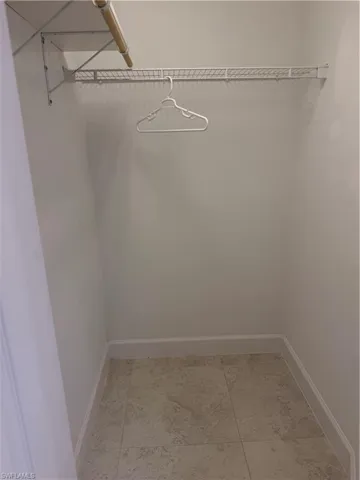1st primary walk in closet featuring a wire shelving system