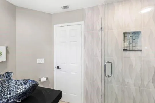 Bathroom featuring a shower with door