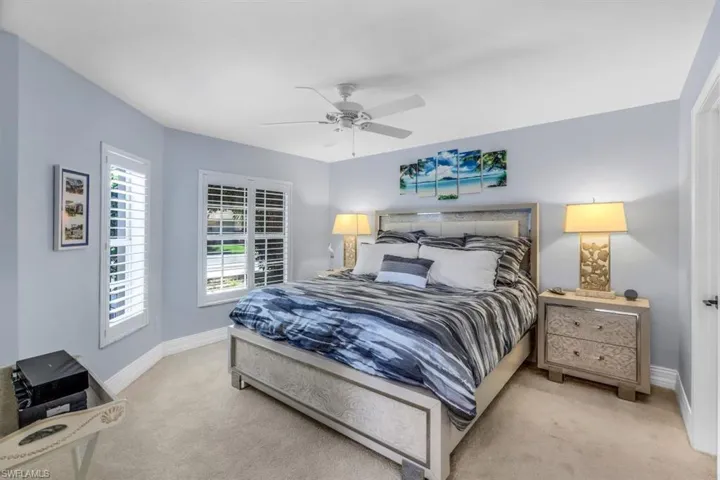 Bedroom featuring light colored carpet and ceiling fan