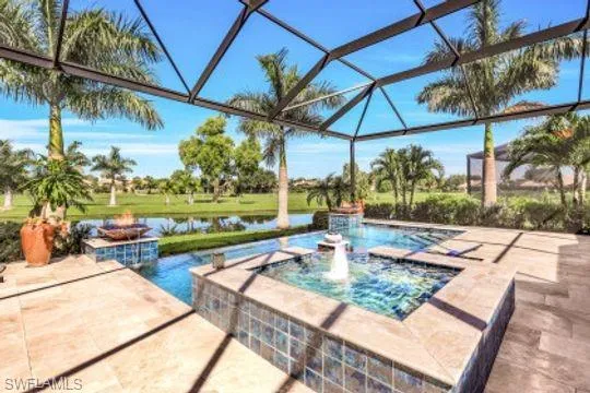 View of pool with a water view, pool water feature, a patio, and glass enclosure