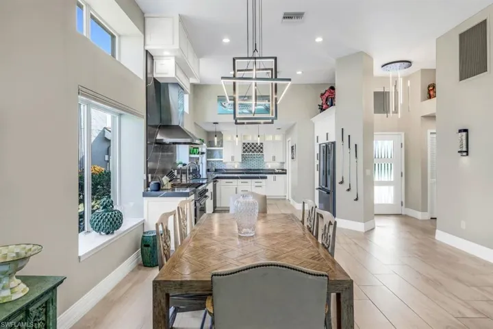 Dining space featuring a high ceiling and light hardwood / wood-style floors