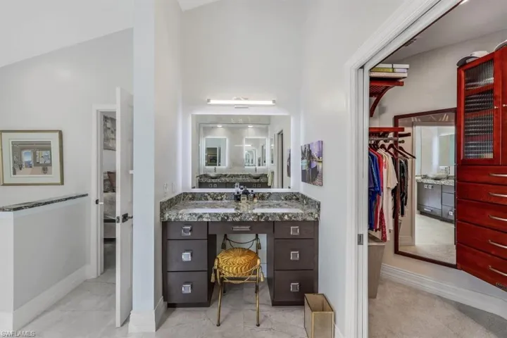 Bathroom with lofted ceiling and vanity