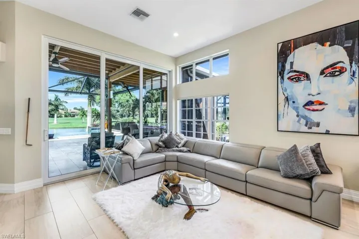 Living room with a healthy amount of sunlight and ceiling fan
