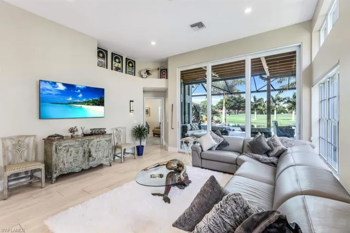 Living room featuring light wood-type flooring and plenty of natural light
