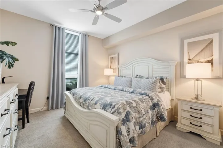 The second bedroom features new carpeting in soothing, cool tones, with natural light streaming in.