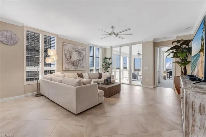Expansive 12-foot sliding glass doors frame breathtaking river views, showcasing spectacular sunsets each and every day, while diagonal-laid subway tile flooring adds a sophisticated touch that beautifully enhances the space.