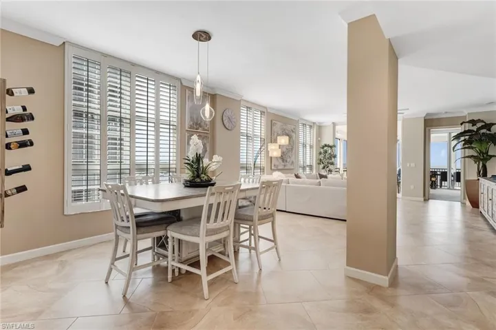 The formal dining area is elegantly appointed with a wall wine rack and captivating views of the river.