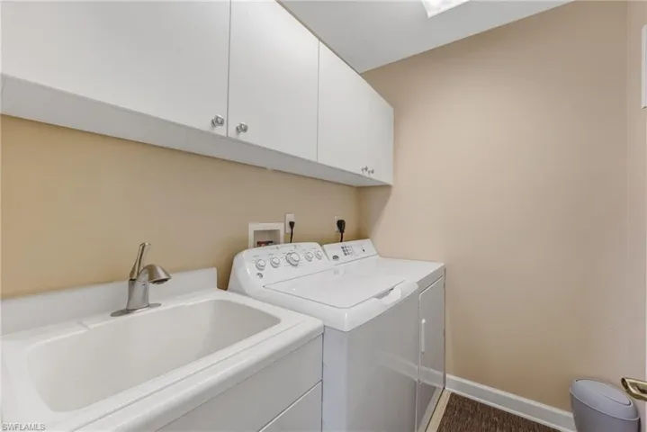 The laundry room features a deep utility tub and ample additional storage for added convenience.