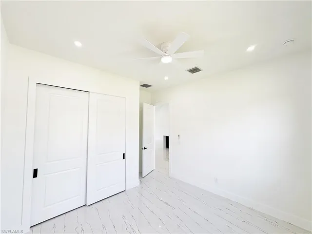 Bright interior space featuring white walls and white baseboards