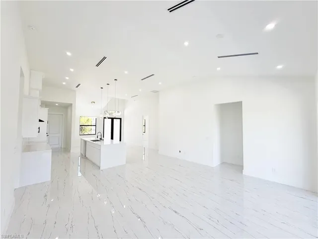 Expansive open-concept living space with large format porcelain tile flooring