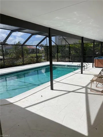 View of swimming pool with a patio and a lanai