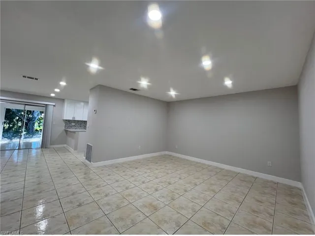 Spare room with light tile patterned floors and baseboards