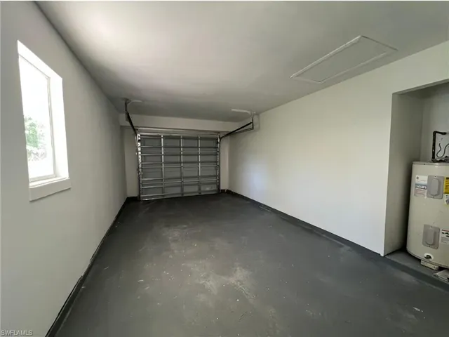 Garage featuring electric water heater
