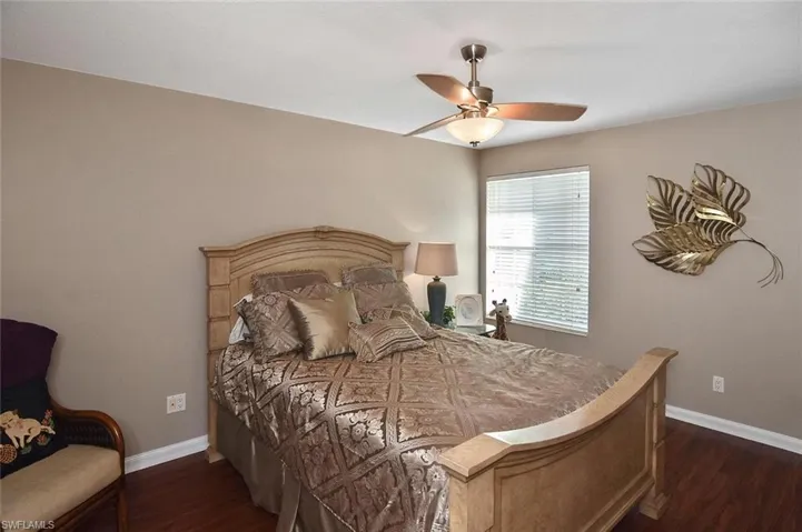 Wood-finish flooring, ceiling fan with integrated lighting, and a window with blinds