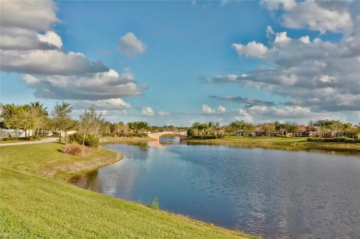 Lakeside setting with a pedestrian bridge and mature landscaping