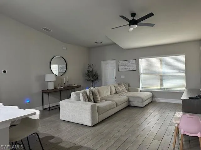 Living room featuring hardwood / wood-style floors and ceiling fan
