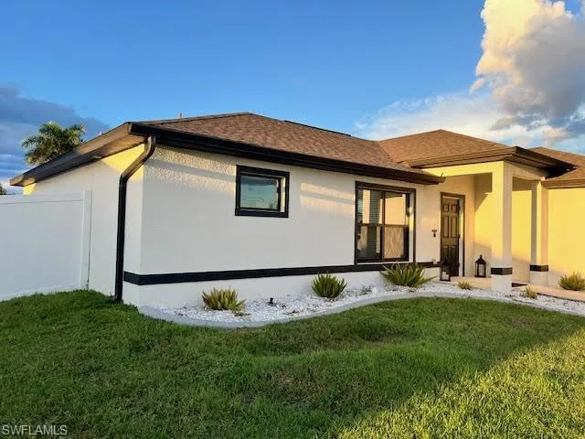 Rear view of property featuring a yard