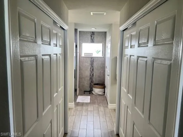 Bathroom featuring hardwood / wood-style flooring and tiled shower
