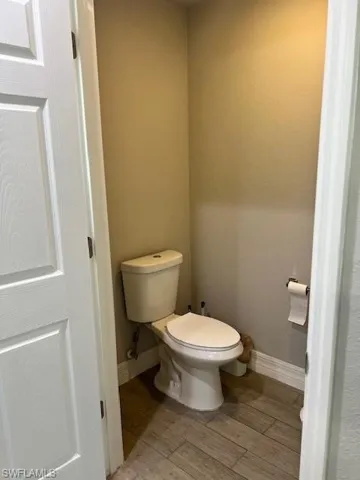 Bathroom with hardwood / wood-style floors and toilet