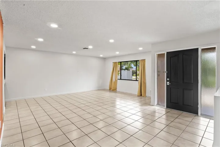 Foyer featuring recessed lighting, a textured ceiling, and light tile patterned floors