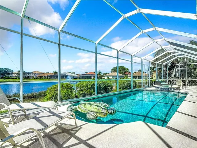 View of pool with a lanai, a patio, and a water view