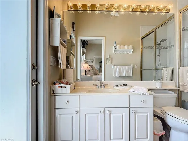 Bathroom with walk in shower, vanity, and toilet