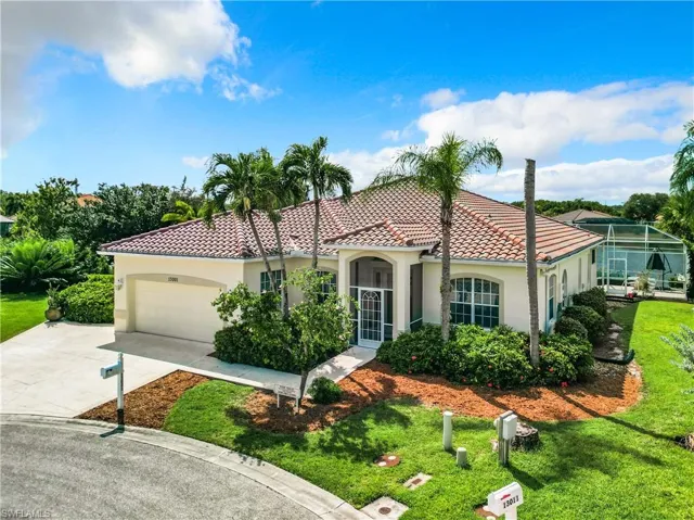 Mediterranean / spanish-style home with a garage and a front yard