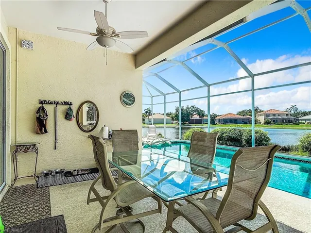View of patio / terrace featuring a lanai and a water view