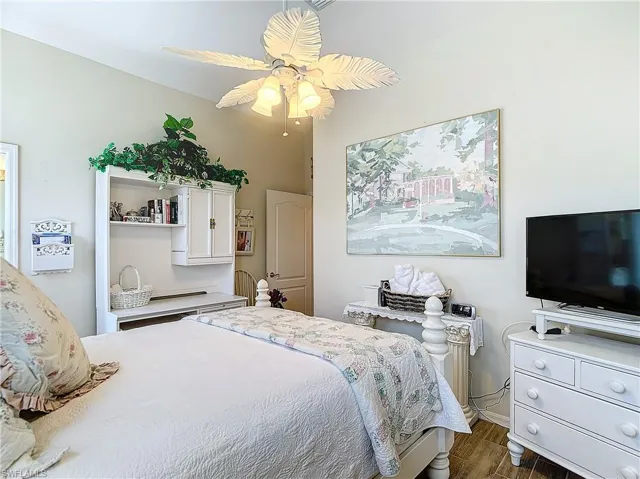 Bedroom featuring ceiling fan and dark hardwood / wood-style floors