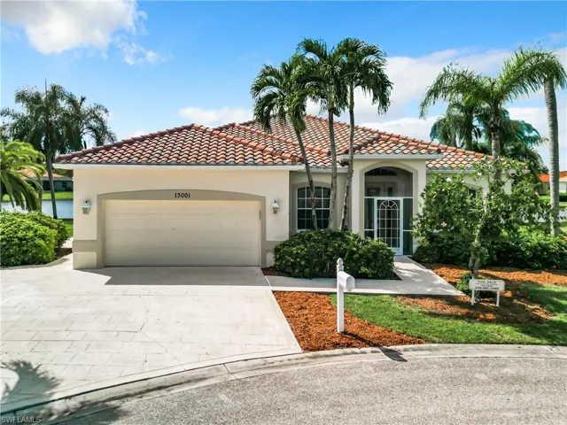 Mediterranean / spanish-style house with a garage