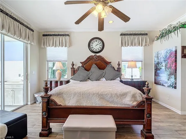 Bedroom with ceiling fan, hardwood / wood-style flooring, ornamental molding, and multiple windows