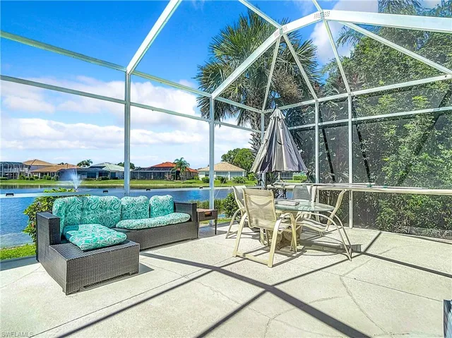 View of patio featuring a lanai and a water view