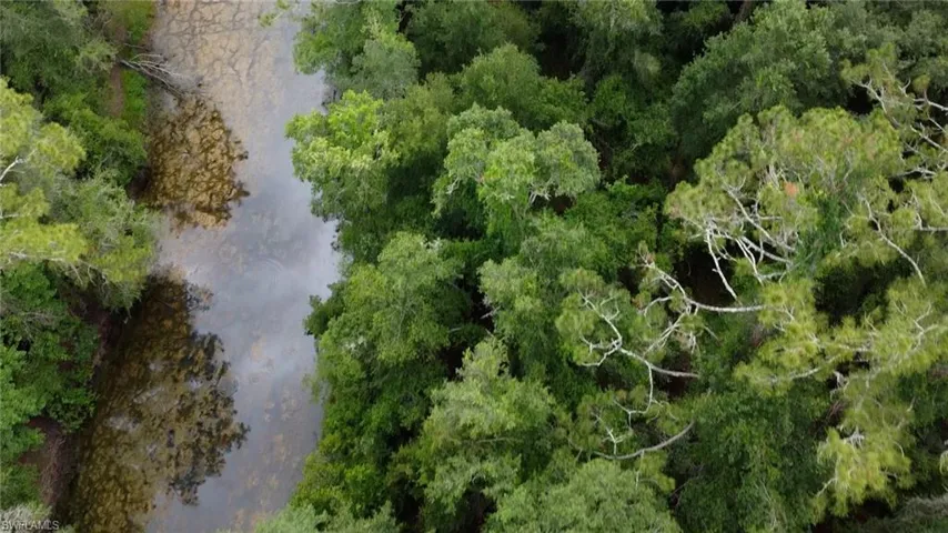 Aerial overview of property's location with a nearby body of water