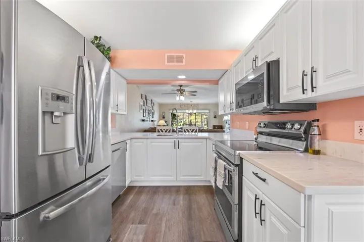 Kitchen with eat-at counter and view to living area