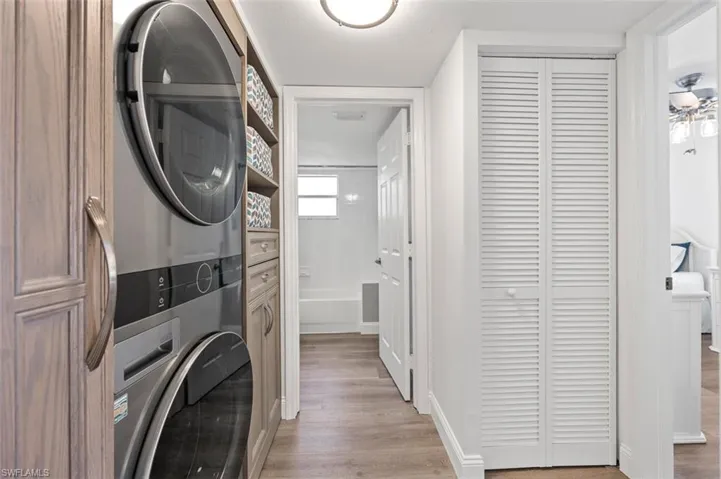 Hallway to guest quarters featuring built-in laundry center