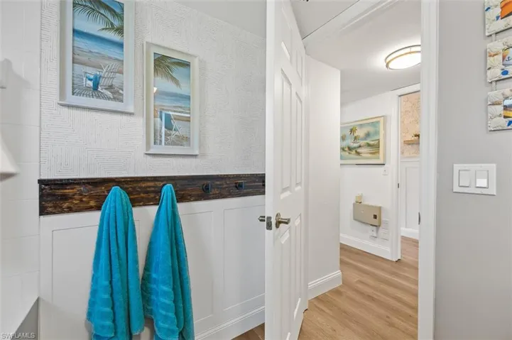 Feature wall in guest bathroom with wallpaper and wood trim